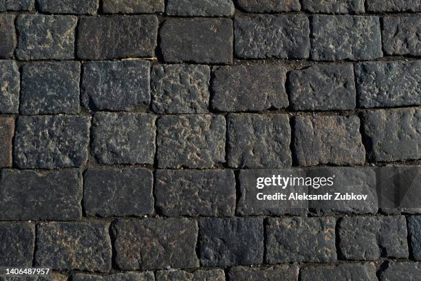 gray paving stones, paved sidewalk, stone path. textured background. - cobblestone floor stock pictures, royalty-free photos & images