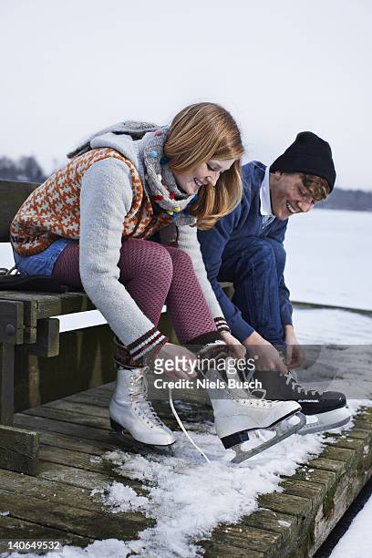 couple ice skating on lake - couple skating stock pictures, royalty-free photos & images