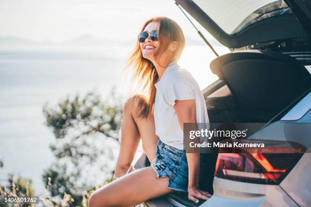 woman enjoying summer seaside road trip. - comfortable car stock pictures, royalty-free photos & images