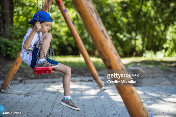 kid on a swing - only boys stock pictures, royalty-free photos & images