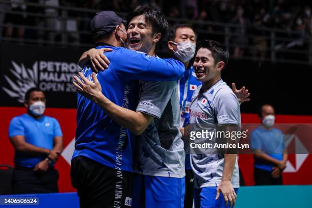 Yugo Kobayashi and Takuro Hoki of Japan celebrate the victory with their coaches after winning the Men's Doubles Finals match against Muhammad Rian...