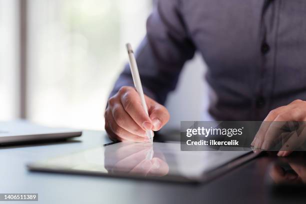 businessman signing digital contract on tablet - intelligent digital signage stock pictures, royalty-free photos & images