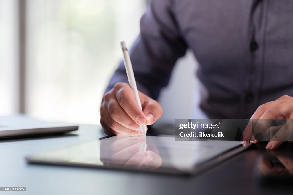 Businessman Signing Digital Contract On Tablet