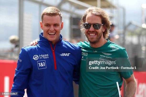 Sebastian Vettel of Germany and Aston Martin F1 Team and Mick Schumacher of Germany and Haas F1 talk on the drivers parade prior to the F1 Grand Prix...