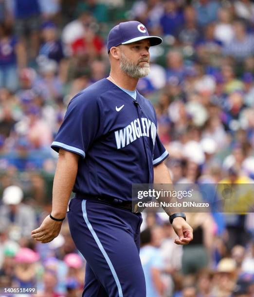 Manager David Ross of the Chicago Cubs walks to the dugout after making a pitching change during the sixth inning of a game against the Boston Red...