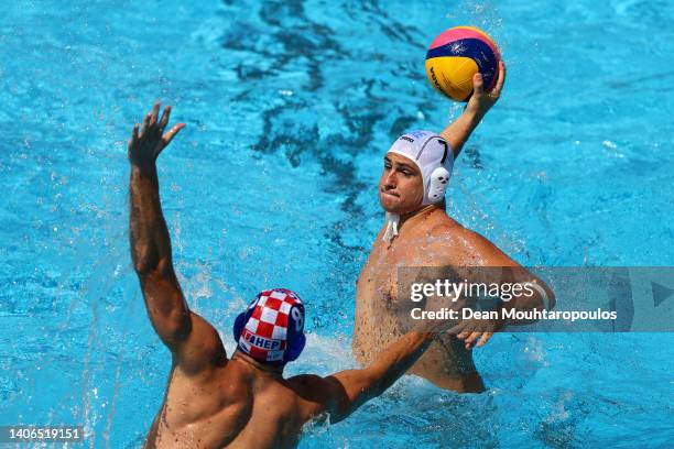 Georgios Dervisis of Team Greece shoots whilst under pressure from Marko Zuvela of Team Croatia during the Men's Water Polo Bronze Medal Match...