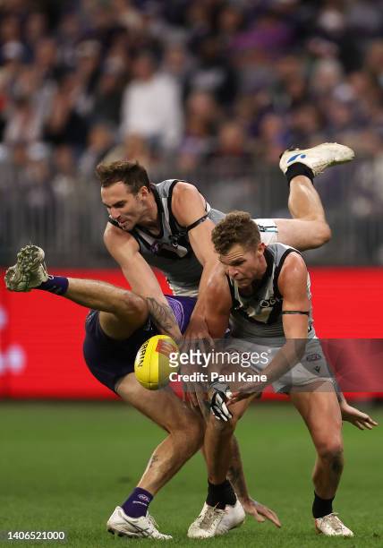 Nathan Wilson of the Dockers contests for the ball against Jeremy Finlayson and Dan Houston of the Power during the round 16 AFL match between the...