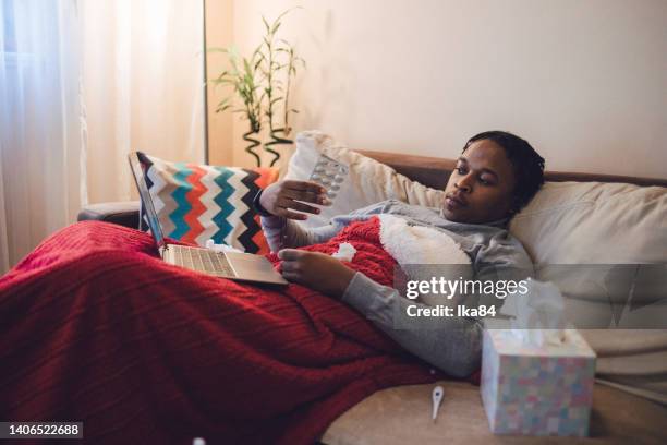 young ill african-american man having interaction with doctor over laptop - consultation lake stock pictures, royalty-free photos & images