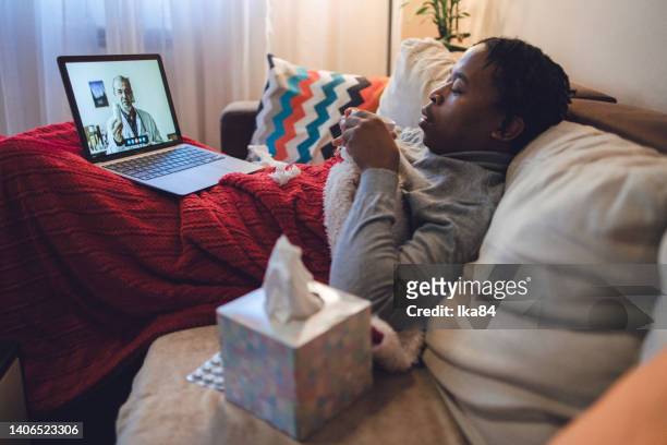 young ill african-american man having interaction with doctor over laptop - consultation lake bildbanksfoton och bilder