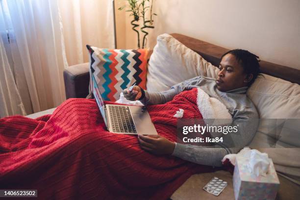 young ill african-american man having interaction with doctor over laptop - consultation lake stock pictures, royalty-free photos & images