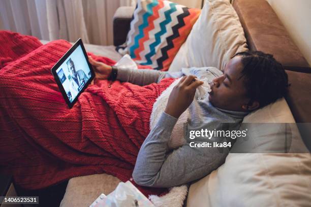 young ill african-american man having interaction with doctor over laptop - consultation lake stock pictures, royalty-free photos & images