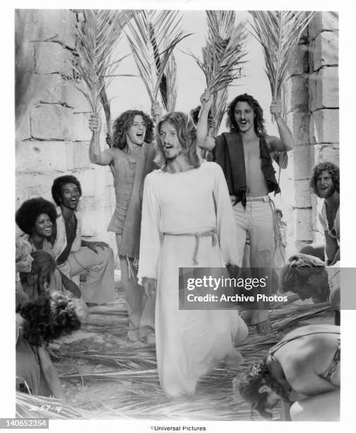 The Apostles and their women lay down palm fronds as Ted Neeley enters Jerusalem followed by Richard Orbach and Robert Lupone in a scene from the...