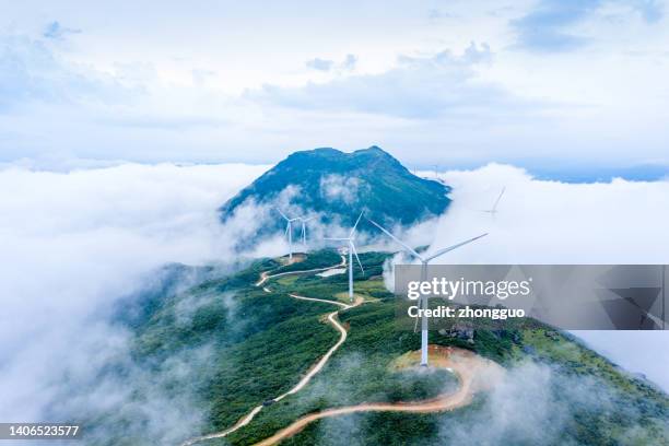 high mountains, sea of clouds and wind turbines - dramatic sky perspective stock pictures, royalty-free photos & images