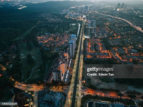 evening drone point of view intersection of suburb with settlement and golf course - petaling jaya stock pictures, royalty-free photos & images