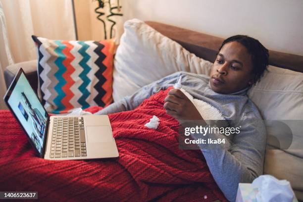 young ill african-american man having interaction with doctor over laptop - consultation lake bildbanksfoton och bilder
