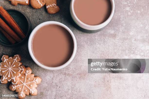 homemade hot chocolate, two mugs and gingerbread cookie on christmas table. - hot chocolate stock pictures, royalty-free photos & images
