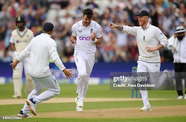 James Anderson of England celebrates taking the wicket of Shubman Gill of India with Ben Stokes and Ollie Pope during Day Three of the Fifth LV=...