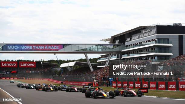 Max Verstappen of the Netherlands driving the Oracle Red Bull Racing RB18 and Carlos Sainz of Spain driving the Ferrari F1-75 battle for track...