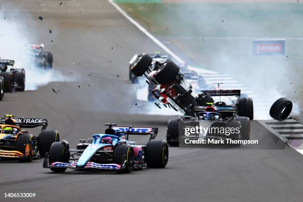 Zhou Guanyu of China driving the Alfa Romeo F1 C42 Ferrari crashes at the start during the F1 Grand Prix of Great Britain at Silverstone on July 03,...