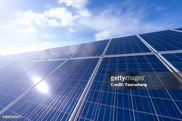 detail view of solar panel under the sunny blue sky - pannello solare foto e immagini stock