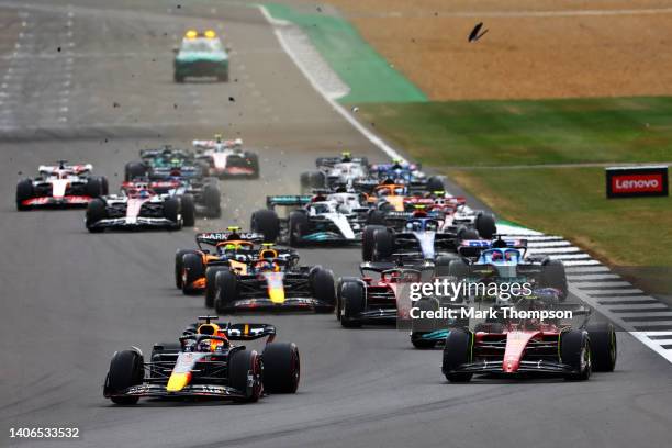 Max Verstappen of the Netherlands driving the Oracle Red Bull Racing RB18 leads Carlos Sainz of Spain driving the Ferrari F1-75 and the rest of the...