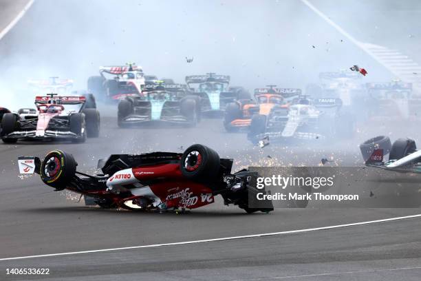 Zhou Guanyu of China driving the Alfa Romeo F1 C42 Ferrari crashes at the start during the F1 Grand Prix of Great Britain at Silverstone on July 03,...