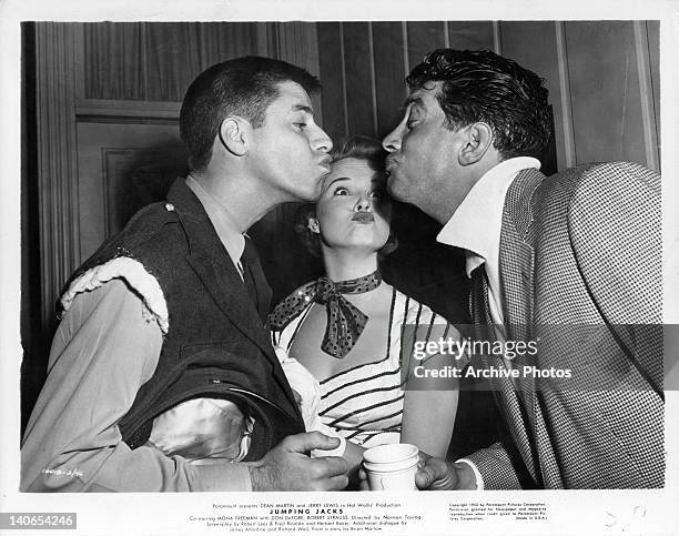 Jerry Lewis, Mona Freeman, and Dean Martin pucker up in a scene from the film 'Jumping Jacks', 1952.