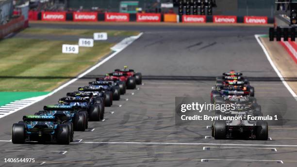 The drivers line up on the grid for the start of the F1 Grand Prix of Great Britain at Silverstone on July 03, 2022 in Northampton, England.