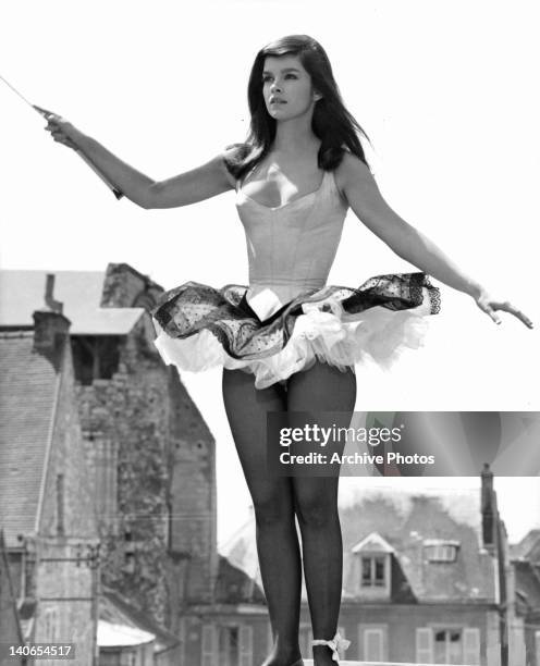Genevieve Bujold outside waving wand in a scene from the film 'The King Of Hearts', 1966.