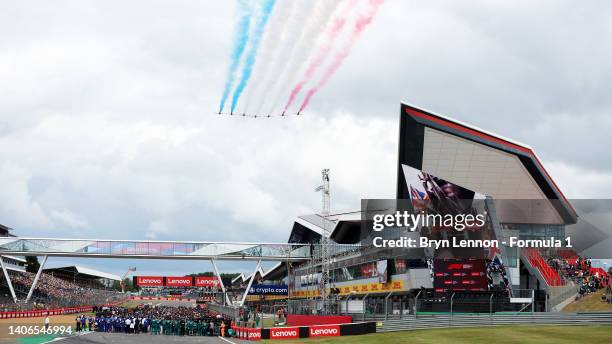 The Red Arrows fly over the grid before the start of the F1 Grand Prix of Great Britain at Silverstone on July 03, 2022 in Northampton, England.