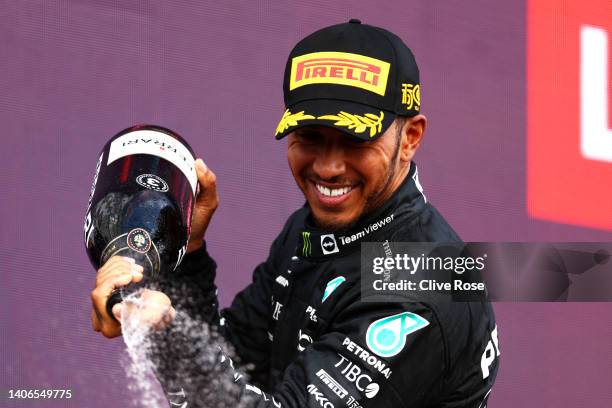 Third placed Lewis Hamilton of Great Britain and Mercedes celebrates on the podium during the F1 Grand Prix of Great Britain at Silverstone on July...