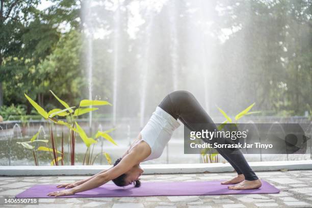 women doing yoga in the garden - yoga day stock pictures, royalty-free photos & images