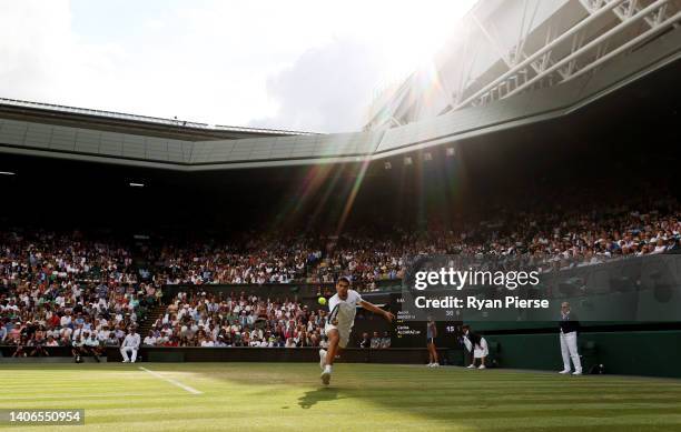 Carlos Alcaraz of Spain plays a backhand against Jannik Sinner of Italy during their Men's Singles Fourth Round match on day seven of The...