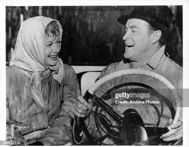 Lucille Ball and Bob Hope soaked and laughing in a scene from the film 'The Facts Of Life', 1960.