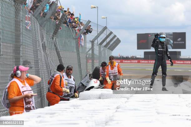 George Russell of Mercedes and Great Britain calls for help after his crash with Guanyu Zhou of Alfa Romeo and China during the F1 Grand Prix of...