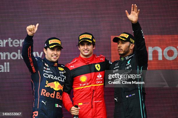 Race winner Carlos Sainz of Spain and Ferrari, Second placed Sergio Perez of Mexico and Oracle Red Bull Racing and Third placed Lewis Hamilton of...