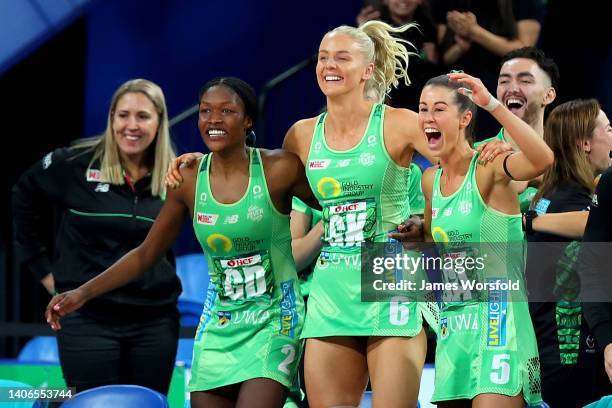 Sunday Aryang, Rudi Ellis and Emma Cosh of the fever celebrate from the bench during the Super Netball Grand Final match between West Coast Fever and...