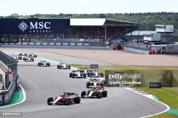Charles Leclerc of Monaco driving the Ferrari F1-75 leads a line of cars on track during the F1 Grand Prix of Great Britain at Silverstone on July...