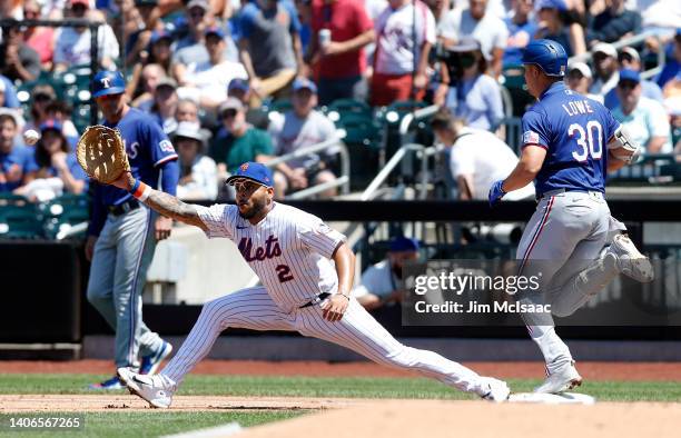 Nathaniel Lowe of the Texas Rangers beats the throw to Dominic Smith of the New York Mets for an infield single in the second inning at Citi Field on...