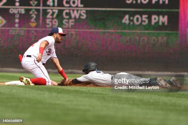 Luis Garcia of the Washington Nationals tags out Jon Berti of the Miami Marlins trying to steal second in the third inning during a baseball game at...