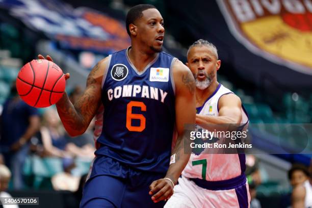 Mario Chalmers of 3's Company dribbles against Mahmoud Abdul-Rauf of the 3 Headed Monsters during the game in BIG3 Week Three at Comerica Center on...