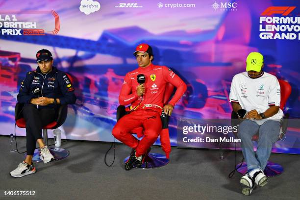 Race winner Carlos Sainz of Spain and Ferrari talks in the drivers press conference alongside Sergio Perez of Mexico and Oracle Red Bull Racing and...