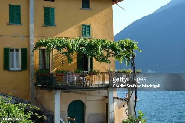 house and balcony with pergola overlooking the lake - snail vine stock pictures, royalty-free photos & images