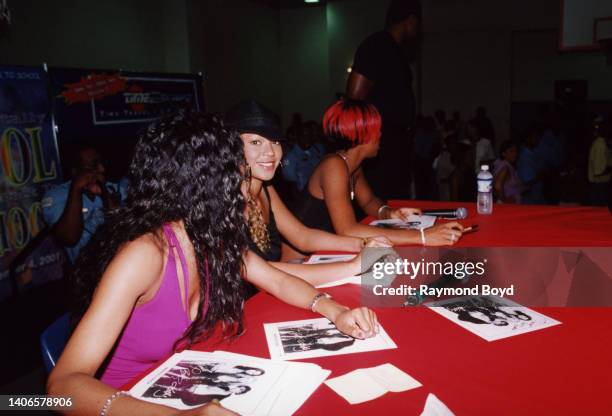 Singers Michelle Williams , Kelly Rowland and Beyoncé Knowles of Destiny's Child signs autographs and greets fans at the South Side YMCA in Chicago,...