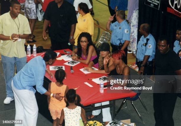 Singers Michelle Williams , Kelly Rowland and Beyoncé Knowles of Destiny's Child signs autographs and greets fans at the South Side YMCA in Chicago,...