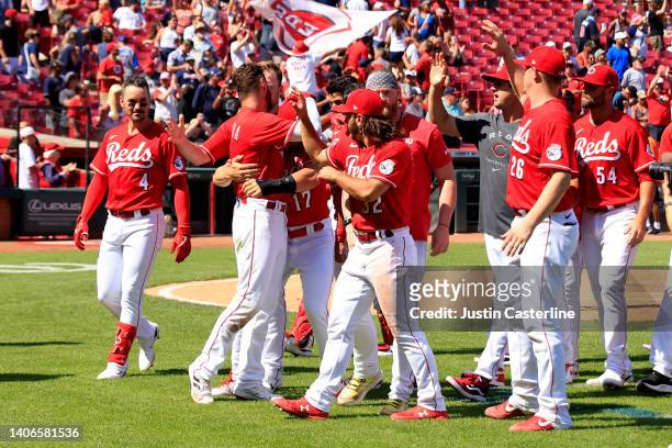 Albert Almora Jr. #3 of the Cincinnati Reds celebrates with teammates after hitting a game winning single during the nineth inning in the game...