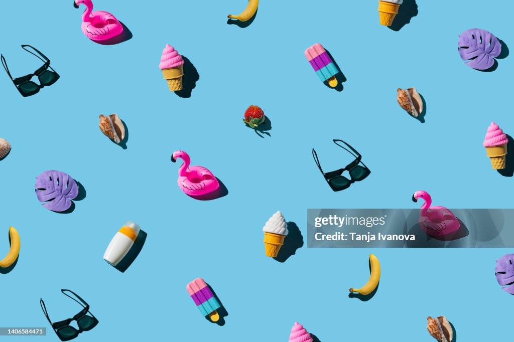 Pattern of various summer objects on a blue background. Minimal summer holidays concept.