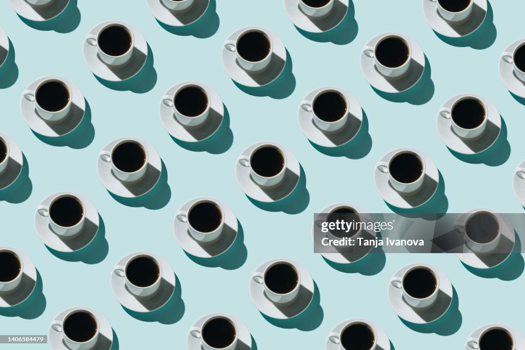 Pattern of coffee cups on blue background