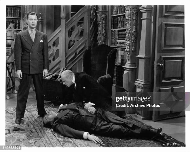 Edmund Gwenn stands over the body of Edwerd Arnold in a scene from the film 'The Earl Of Chicago', 1939.