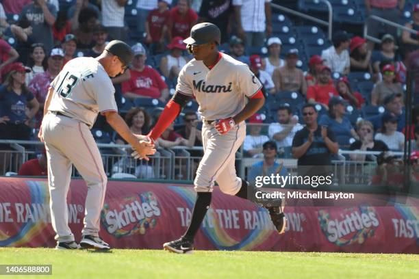 Jesus Sanchez of the Miami Marlins celebrates his a two-run home run in the ninth inning with third base coach Al Pedrique against Washington...